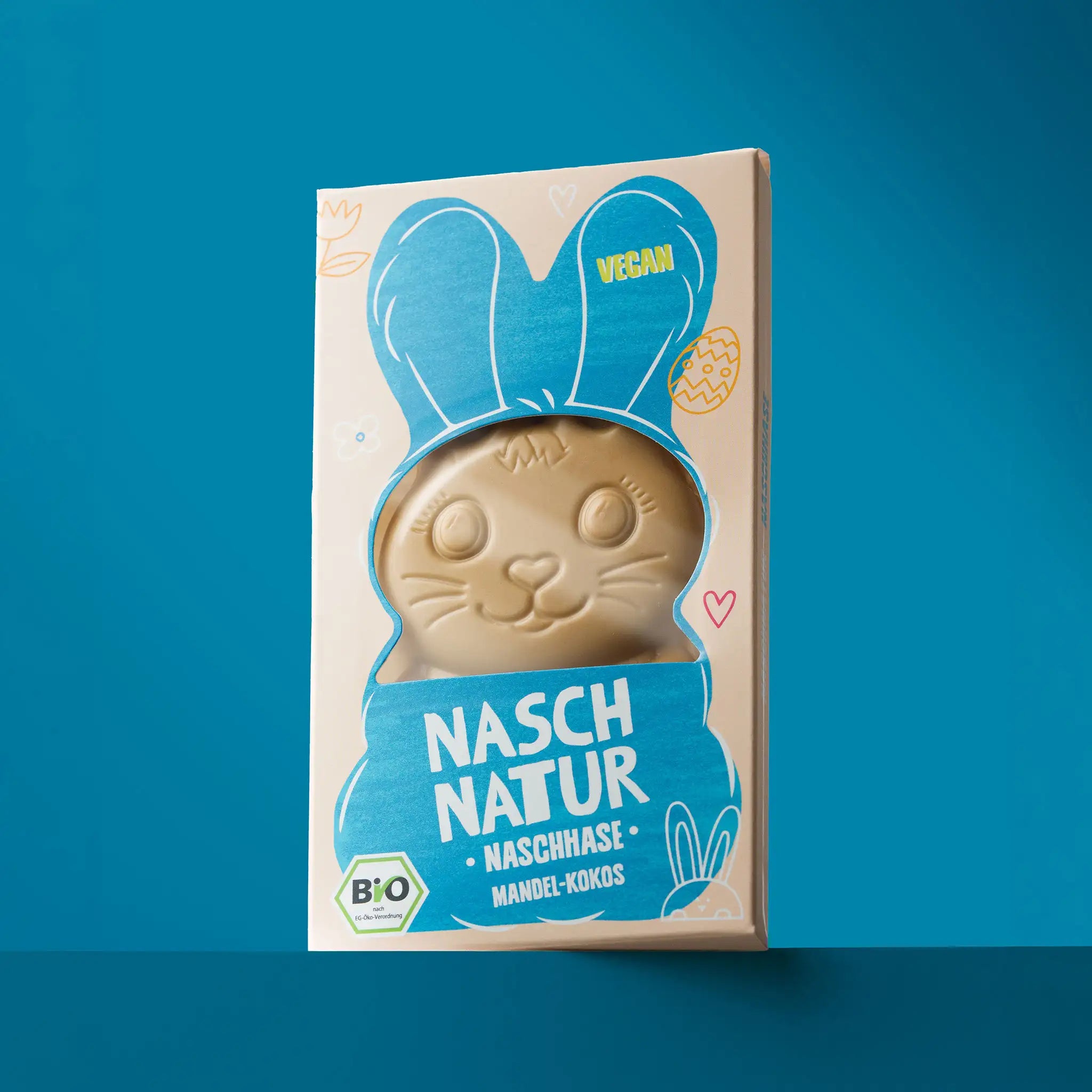 Das ProduktBild des NaschHase Mandel- Kokos. Ohne Zuckerzusatz, mit Datteln gesüßt. Der Osterhase von NaschNatur.